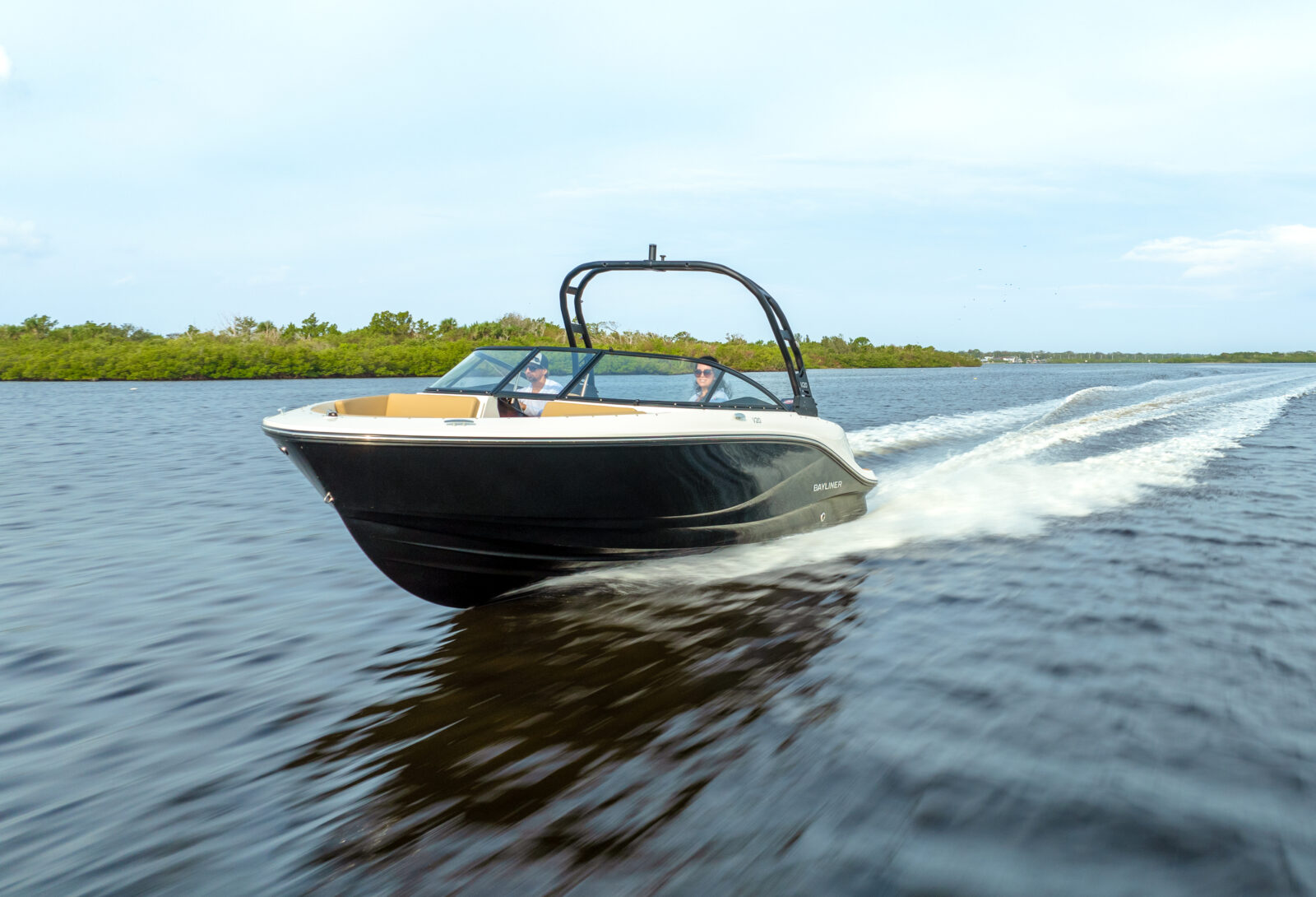 Lancha Bayliner a motor navegando a toda velocidad por el mar, con estela y spray